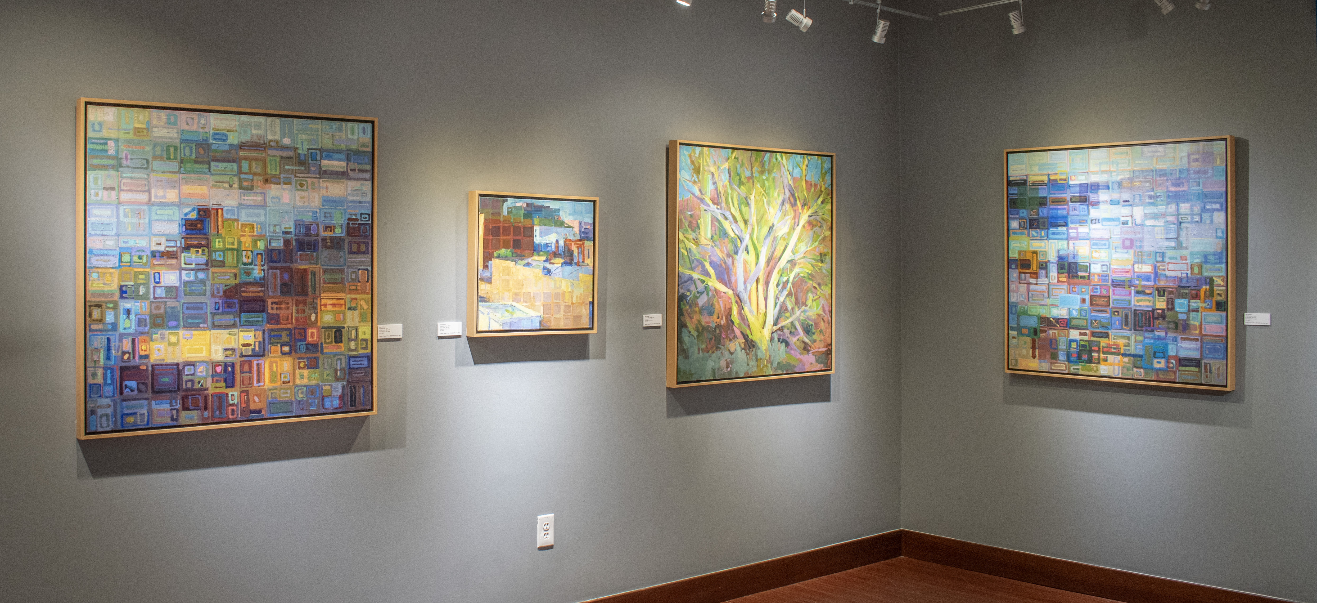 Photograph of the back wall of the gallery featuring work by Joe Forkan.